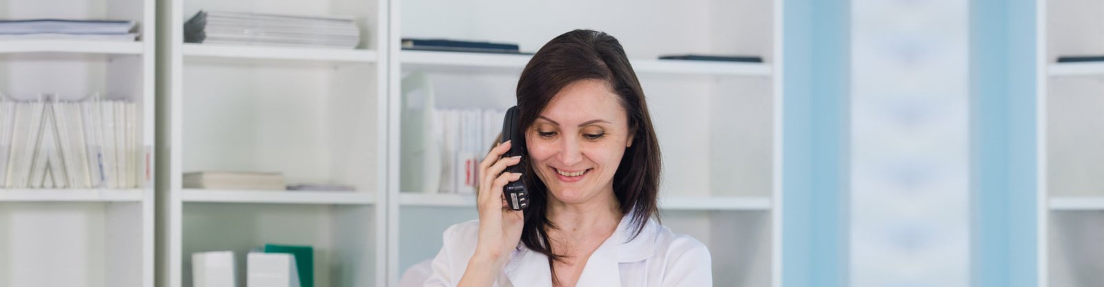 smiling doctor while taking phone call