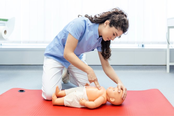 performaing CPR to baby toy